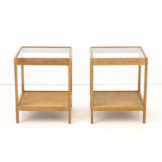 Pair of Modern Glass Top Side Tables, each with woven rattan undertier. 22.25" H x 18" W x 18" D. Provenance: From a New...