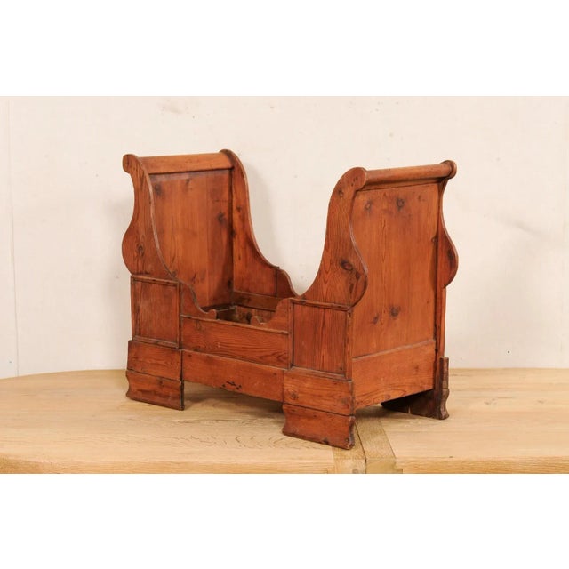 A Swedish carved-wood dog bed from the early 20th century. This antique dog bed from Sweden has a wonderful sleigh bed...