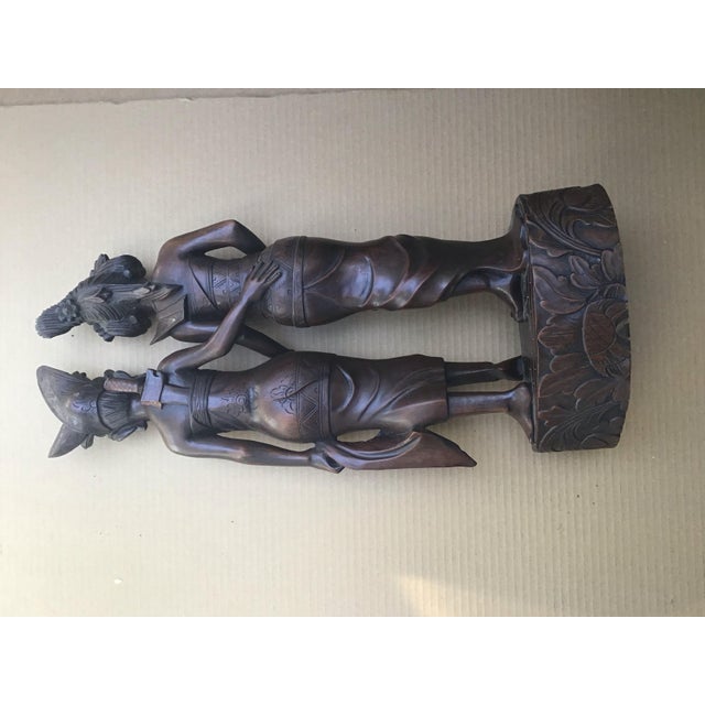 This hand-carved wooden sculpture originates from Klungkung Bali, a region renowned for its long tradition of finely...
