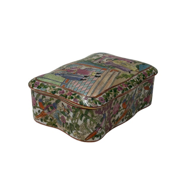 This vintage Chinese porcelain box features a lobed, rectangular silhouette delicately painted in vibrant famille rose...