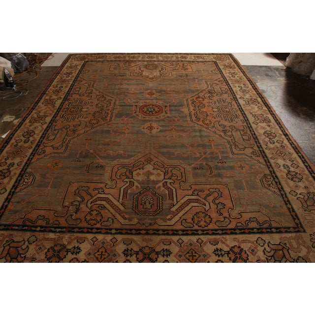 A 10x13 ode to rare antique Oushak rug styles, hand knotted in wool originating from Ireland circa 1920-1930. Representing...