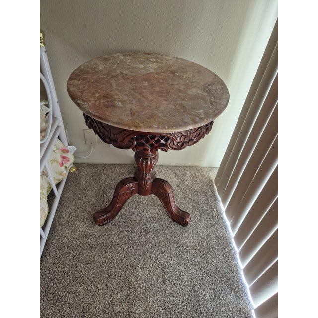 This is a Design Toscano Chantret style marble topped pedestal table featuring a dark wood base with intricate fretwork...