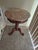 This is a Design Toscano Chantret style marble topped pedestal table featuring a dark wood base with intricate fretwork...