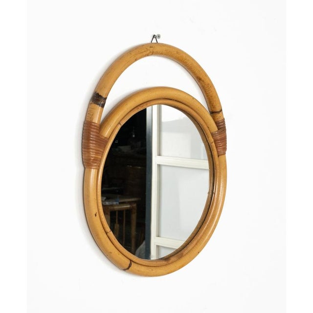 Midcentury beautiful round wall mirror in rattan and bamboo. Made in Italy in the 1970s.
