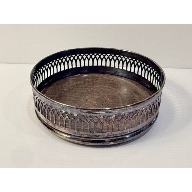 A distinctive 1960s English wine or decanter coaster imported by Eisenberg-Lozano of New York. The circular coaster...
