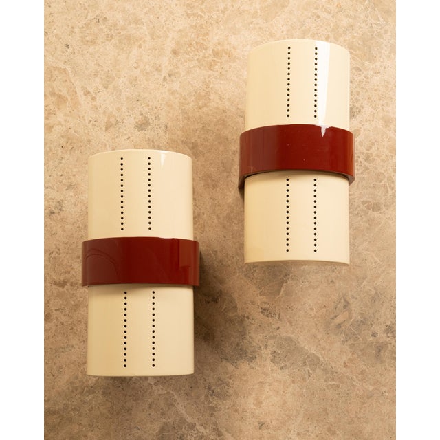 Pair of italian wall sconces from the 1980s. completely refinished in cream and vintage brown/red. each panel, perforated...
