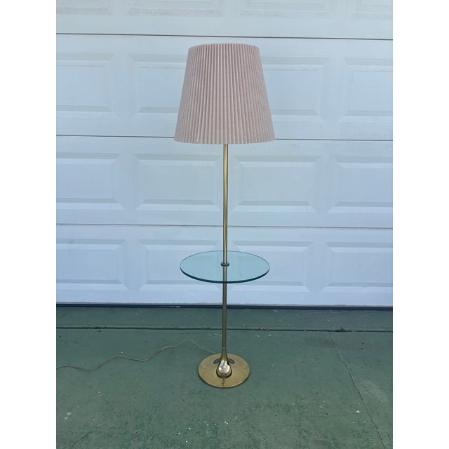 Elegant floor lamp with glass table by Bill Curry for Laurel Lamps. A classic mid century modern tulip style base forming...