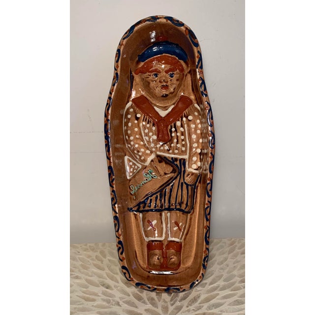 Vintage terra cotta red ware glazed pottery Figural mold, features the name “Hansel” towards the middle. Originally made...