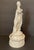 Antique porcelain figure of an artist, possibly a muse, standing with a pallette and paint brush. She is in a robe on a...