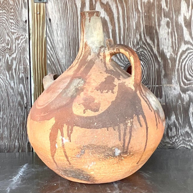 Introduce a touch of rustic charm to your home with this Vintage Terracotta Painted Urn. Expertly crafted and adorned with...