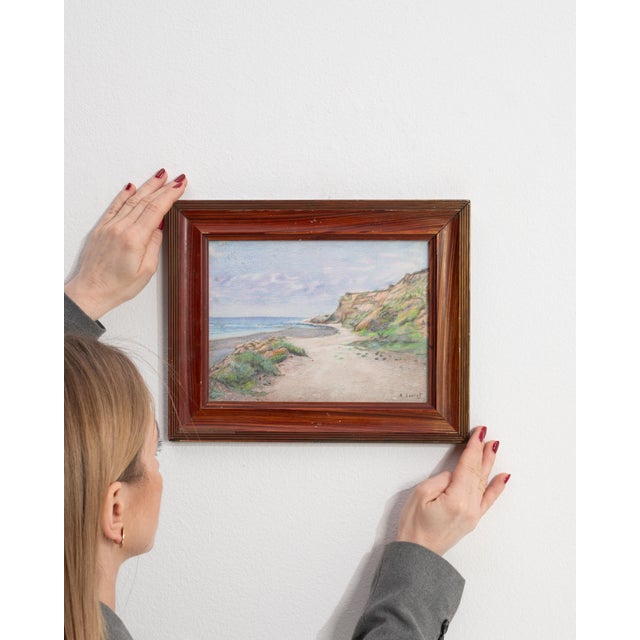 This early 20th century drawing from France is a pastel, housed in a wood and glass frame. Its signed detailing gives the...