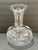 Elegant handblown clear glass decanter featuring a spherical body, narrow collar, and wide flared trumpet neck. Pontil...