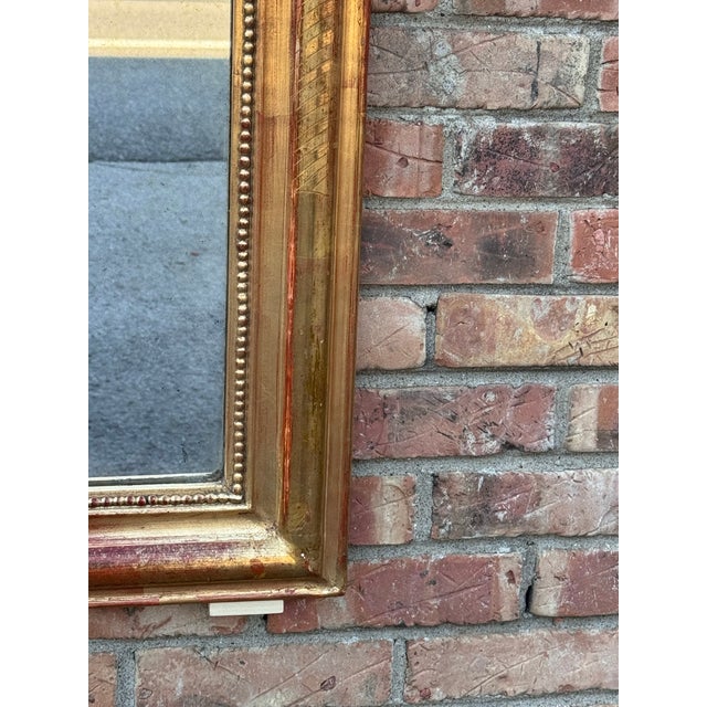 This is a beautiful mid sized gold leafed C. 1880 Louis Philippe mirror! This mirror holds to a simple quiet design...