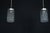 Elegant pair of Italian pendant lights dating from the 1970s, featuring textured glass shades paired with polished...