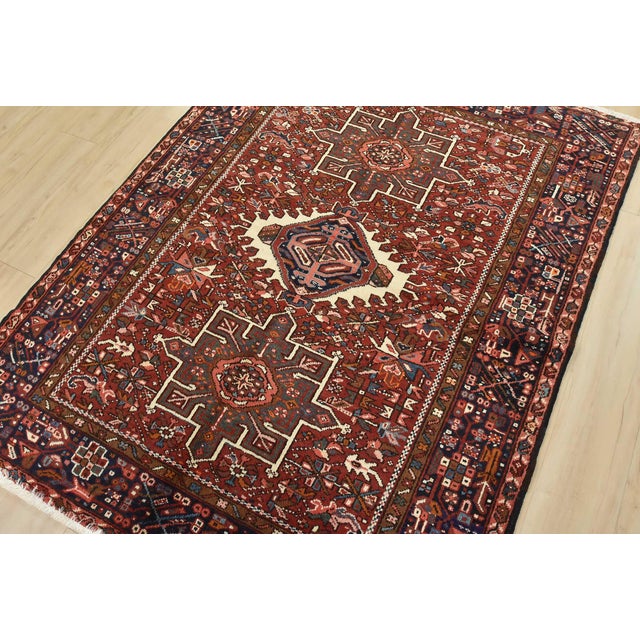This authentic vintage, tribal, geometric Karajeh rug is hand-knotted with an all-wool pile on a cotton foundation. This...