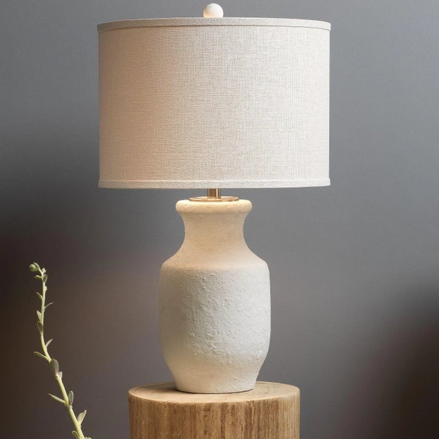A matte textured finish adds a white sandy feel to the ceramic form of the Gilbert Table Lamp. It’s topped off with a...