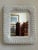 A beautiful mid-20th century white wicker mirror. Love the rectangular shape of this mirror, the deep, thick curves of the...
