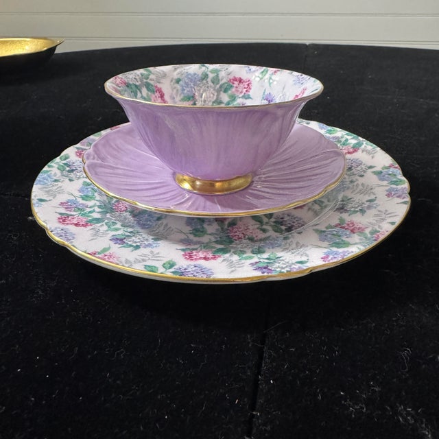 This stunning 3-piece porcelain tea trio was crafted in England by the renowned Shelley Fine Bone China pottery. The set...
