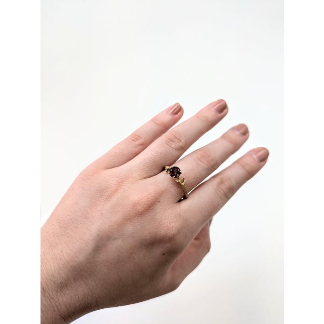 This beautiful ring features a 0.80 carat round Garnet gemstone with natural earth mined diamonds set in solid 14K gold....