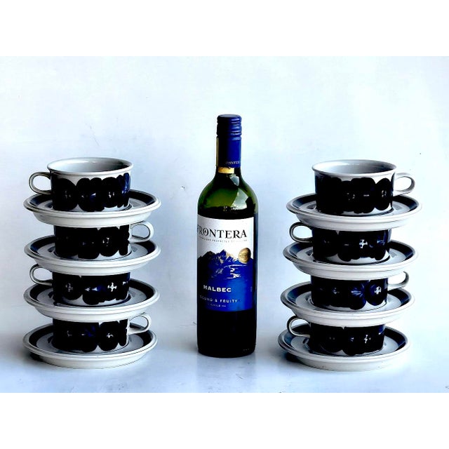 Offered is a set of 8 flat cups and saucers in the Anemone Blue pattern by Arabia of Finland designed by Ulla Procopé. The...