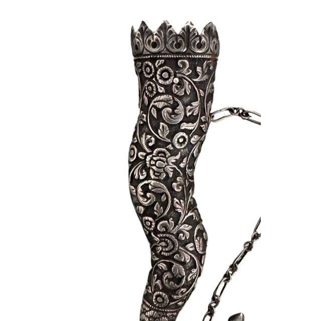 5” H x 1"D Chain: 7" This finely worked silver posy holder, or tussie-mussie, represents a masterclass in mid-to-late...