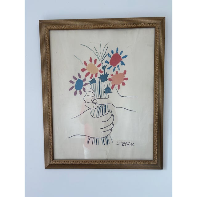 Print of Pablo Picaso with signature dated58. A nice simple work of flowers in a vase held by two hands . Probably worth...