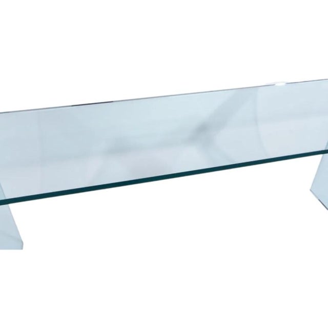 An iconic 1970's glass bracket waterfall-shaped console or sofa table designed by Leon Rosen for the Pace Collection. The...