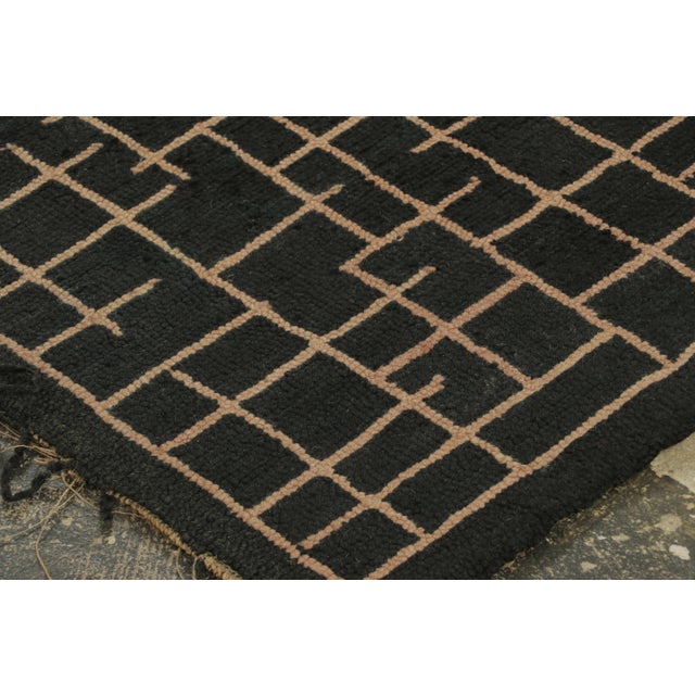 This 8x10 antique hooked rug, circa 1920–1929 features a richly detailed floral design centered within an oval reserve,...