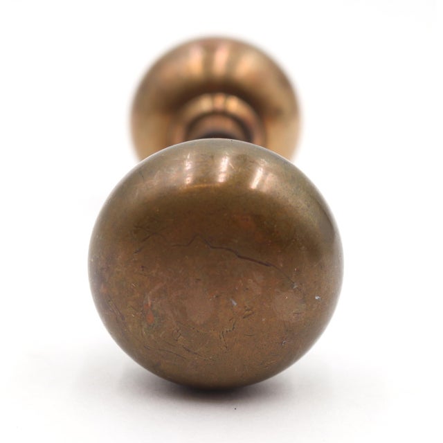 Vintage Classic dark patina brass plain round passage door knobs. Priced as a pair of knobs with a spindle. Good condition...