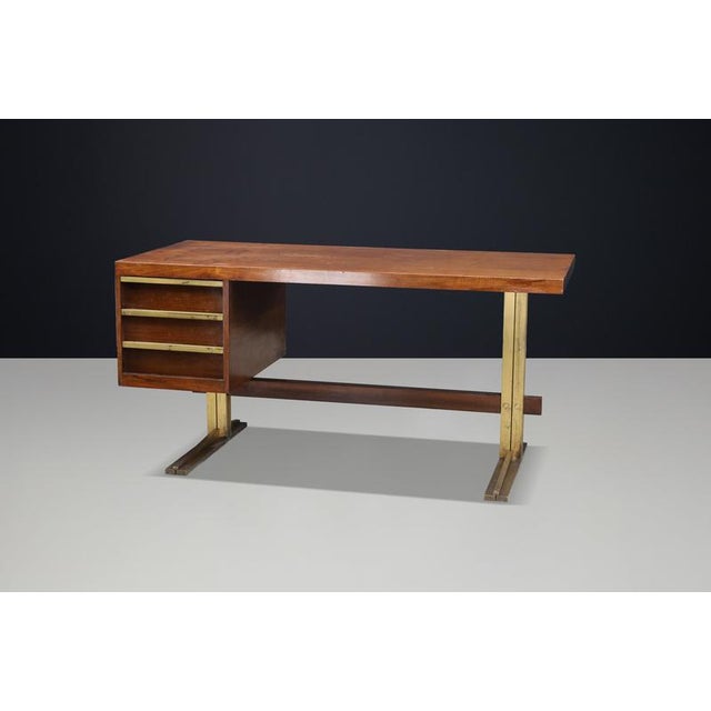 Exceptional Italian Walnut Desk with Patinated Brass Base, Italy, 1950s An exceptional Italian writing desk, handcrafted...