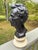 Standing over a foot tall, an imposing bust of Abraham Lincoln, executed in what looks like black basalt on a marble base...