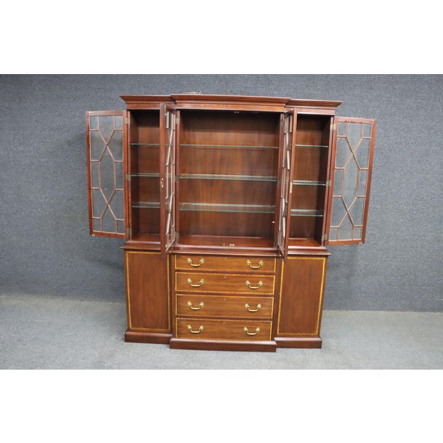 Henkel Harris Virginia Galleries two-piece mahogany breakfront featuring glazed upper display cabinets, interior lighting,...