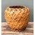 This vintage woven rattan floor basket presents a full, bulbous silhouette, with broad, rounded shoulders that taper...