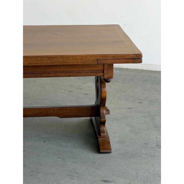W72 W95.5 D40 H31 KC24.75 Leaf W12 Fully refinished vintage trestle dining table featuring sculptural carved end supports,...