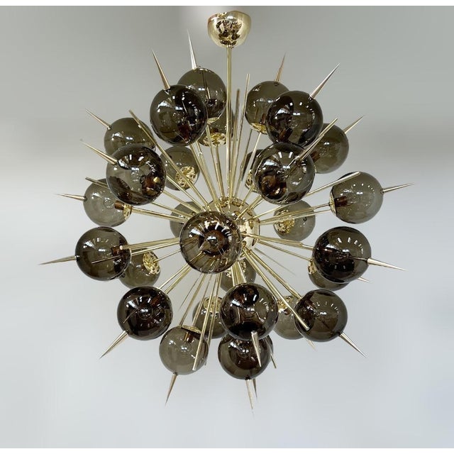 Italian sputnik chandelier with 30 smoky Murano glass globes and solid brass spikes mounted on brass frame in unlacquered...