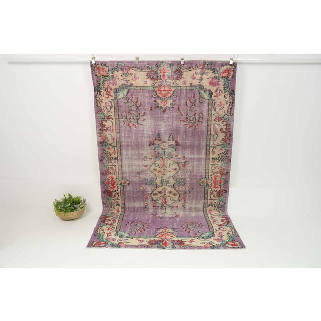 This vintage hand-knotted area rug is a semi-antique vintage area rug. The '70s Eastern Anatolian region's unique rug is...