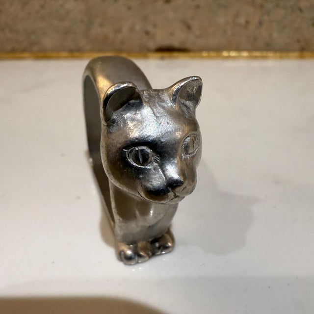 For your consideration, a set of eight (8) modern aluminum napkin rings with cat motif. Unmarked, , designer and country...