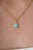 This turquoise pendant features a 0.64 carat natural oval cabochon turquoise set in 14K yellow gold. The center stone...