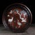 A beautifully crafted Chinese round tray or display stand, made of dark Zitan wood. The tray is enclosed by a low,...