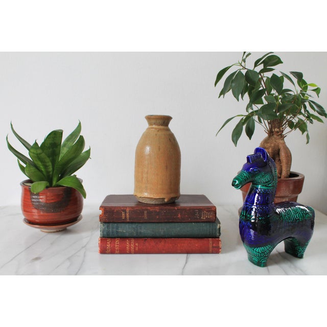 Vintage studio art pottery vase. Signed by artist on bottom. Some small chips around the rim.