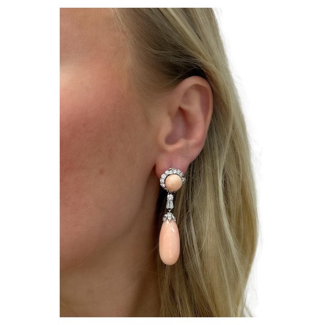 These gorgeous earrings feature two button angel skin coral tops surrounded by round brilliant cut diamonds, two removable...