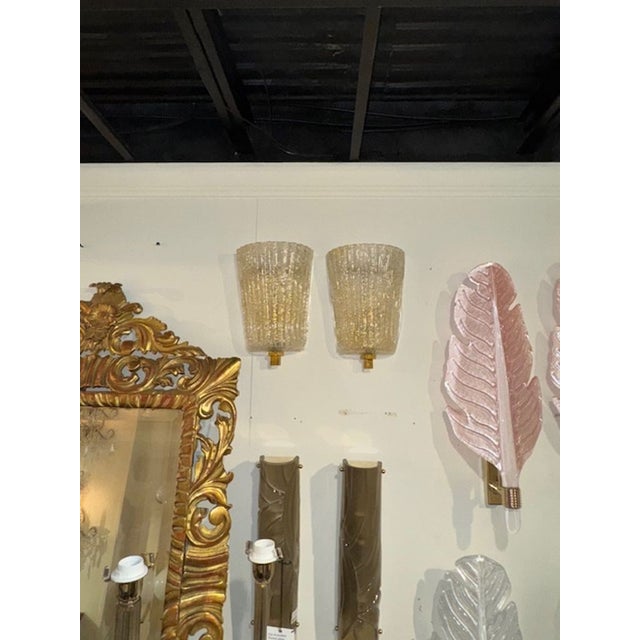 This is a pair of decorative modern gold "Granola"Murano glass shell form sconces. The pair is designed in a Murano style,...