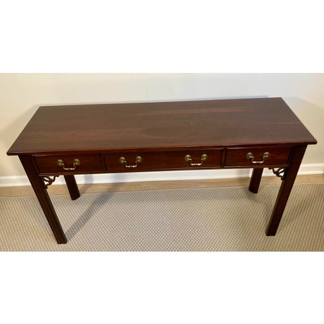 Likely produced in the 1980s or 1990s, this Ethan Allen console table has classic, stately lines and a beautiful finish....