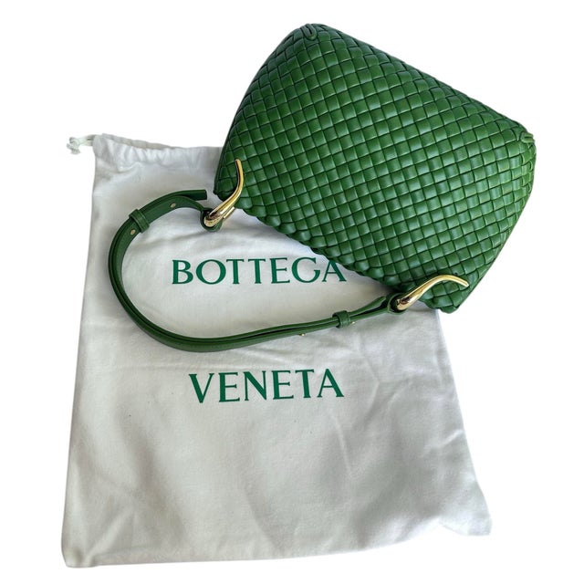 Bottega Veneta's hobo-style shoulder bag is crafted of premium lambskin leather in the label's iconic Intreccio weave...