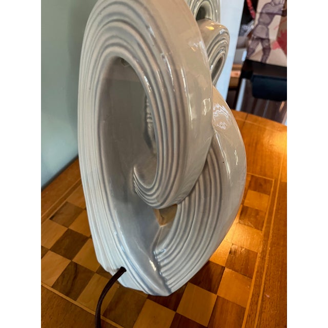 Dynamic pair of mid-century ceramic lamps in a light blue-gray glaze. A terrific near neutral color that works in many...