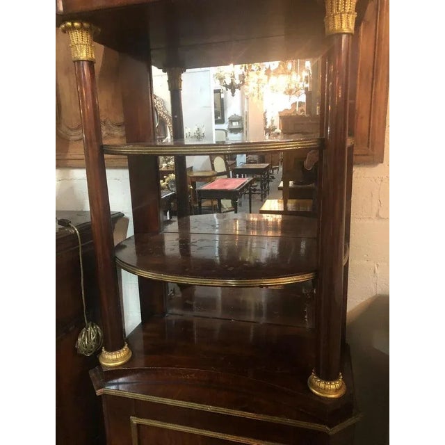 Superb quality and uniquely designed early 19th century neoclassical mahogany étagère with mirrored back. The shaped top...