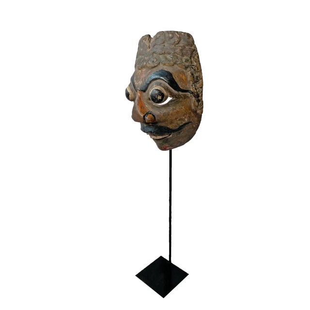 This early 20th century ‘Wayang topeng’ mask was used in Javanese masked dance performances. Height with stand 18.50. It...