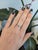 A natural Brazilian alexandrite takes center stage in this solid 14K white gold ring, framed by twelve earth-mined...