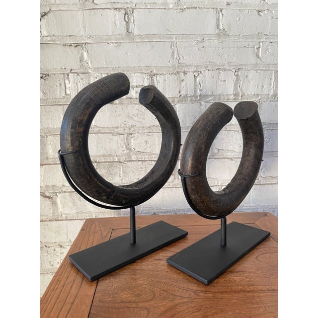 A pair of large currency bracelets in solid bronze from Central Africa. Attributed to the Ngelima of the Congo, these...