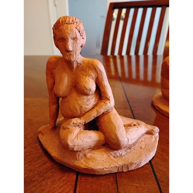 This is a rare, artist-signed pair of handmade studio art terracotta sculptures capturing the beautiful chronological...